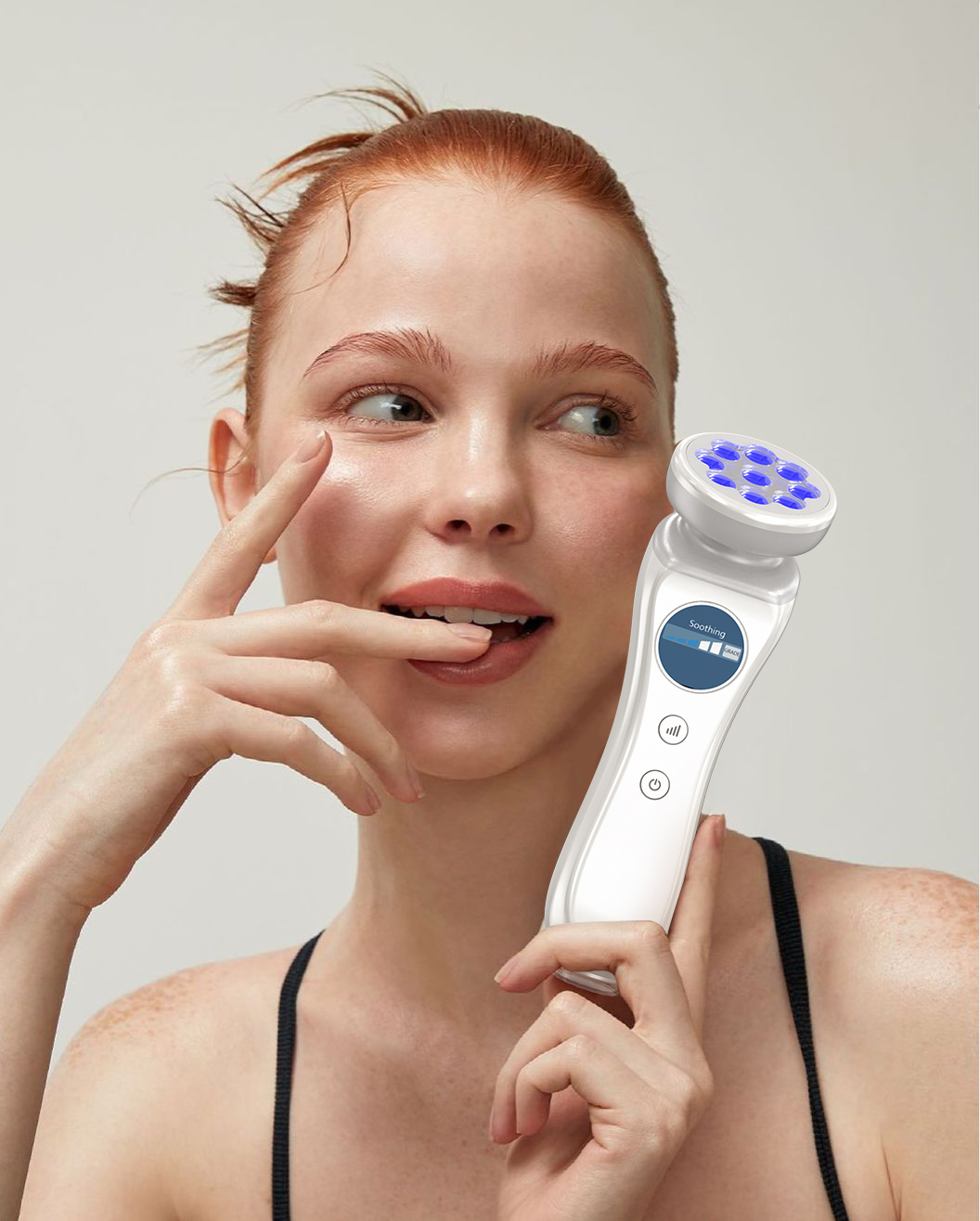 Woman holding SkinDr600 with blue LED head near face